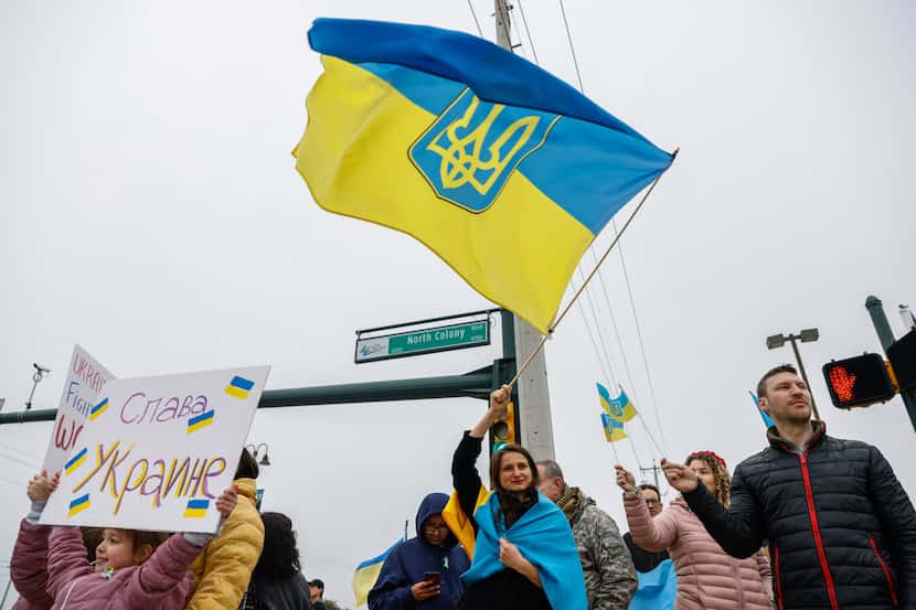 Olya Dyachyshyn waves an Ukrainian flag as they participates in a Ukrainian war rally at the...