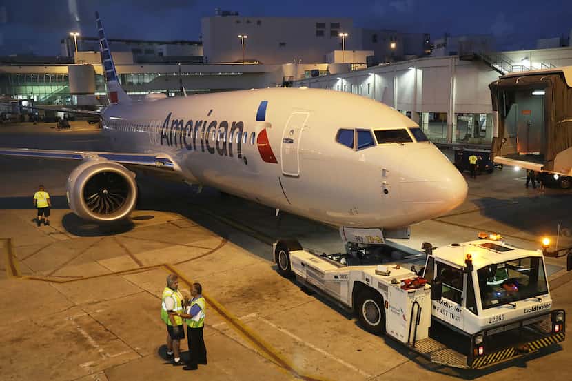A grounded American Airlines Boeing 737 Max 8 is towed to another location at Miami...