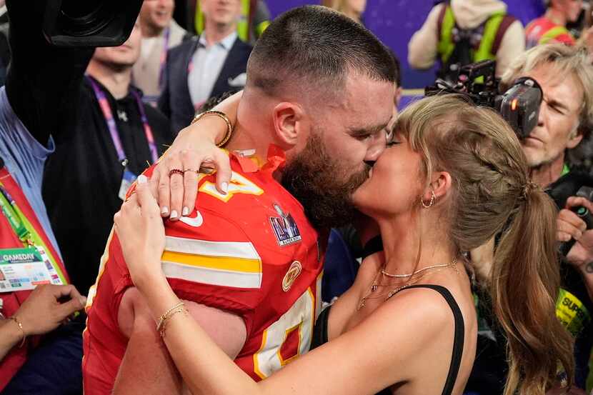 Kansas City Chiefs tight end Travis Kelce kisses Taylor Swift after the Super Bowl on Sunday...