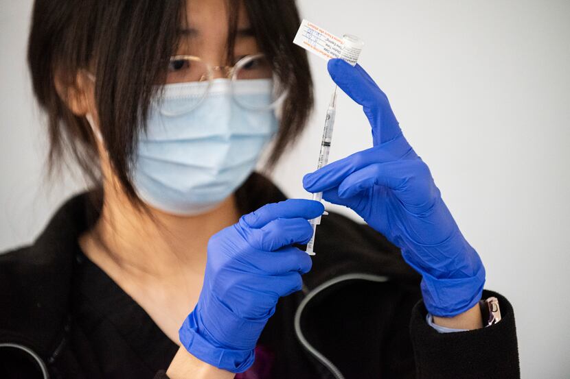 Pharmacist Henna Choi of Parkland Hospital prepares a Pfizer vaccine during a vaccination...