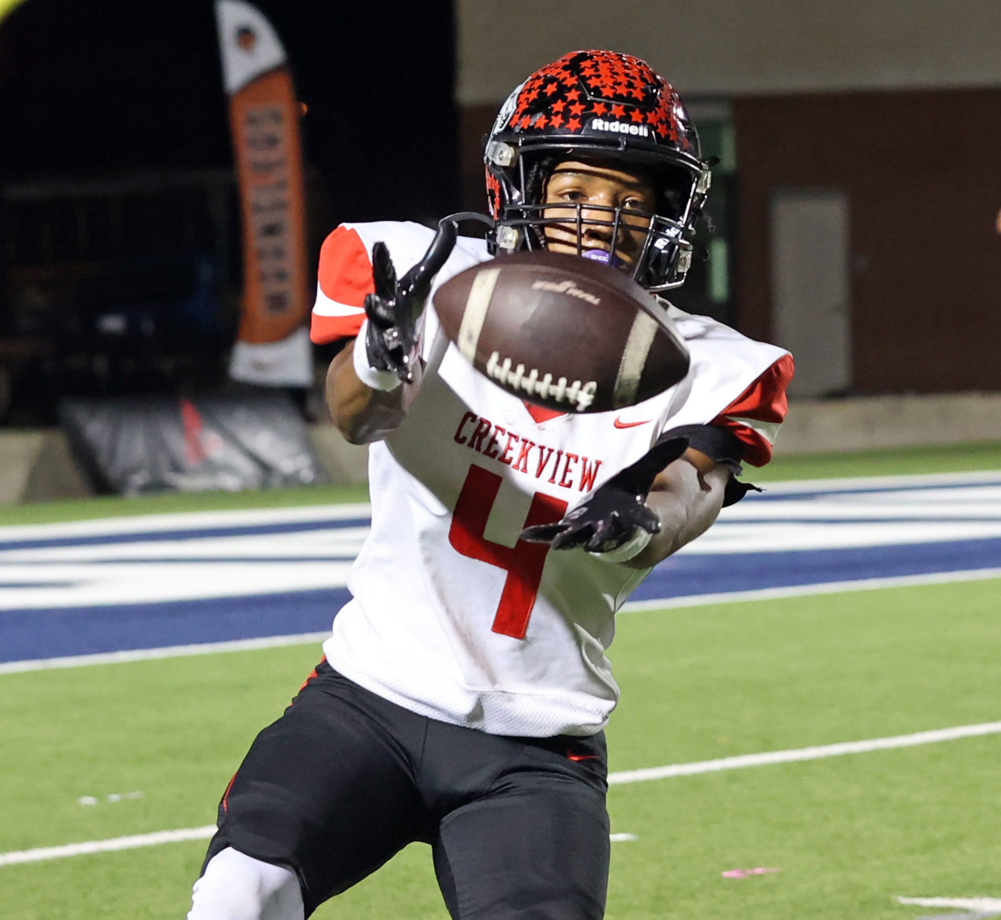 Carrollton Creekview High’s Isaiah Holliday (4) garbs a kick during the first half of a high...