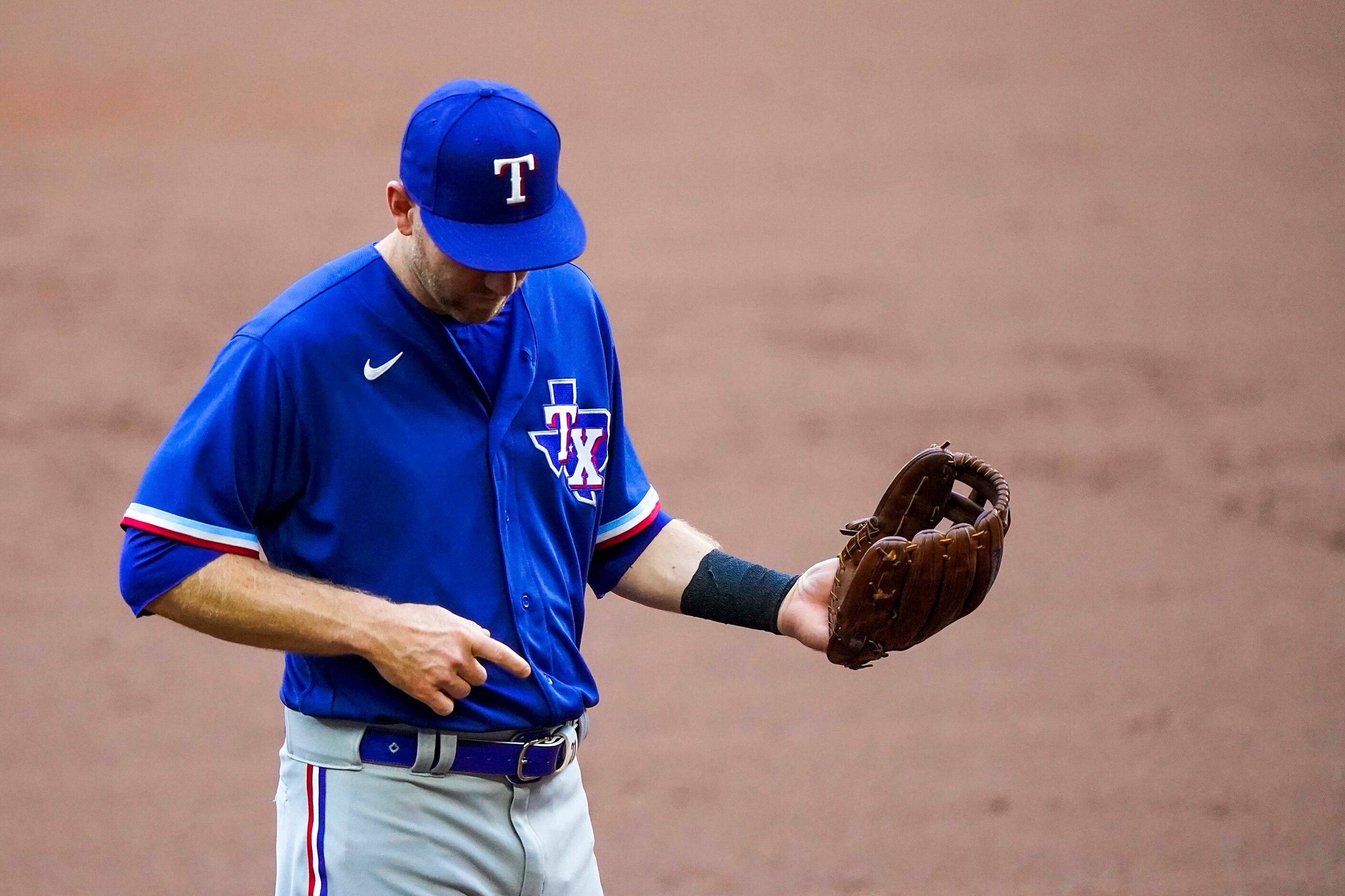 Third baseman Todd Frazier plays air guitar between batters in an intrasquad game during...