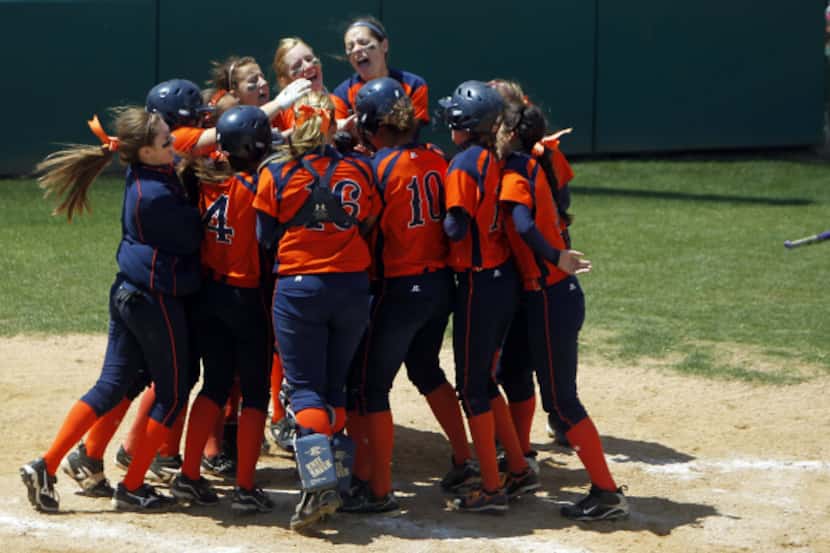 Frisco Wakeland players mob Brittany
Gehle after she hit a game-winning three-run home run...