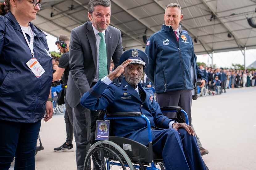 U.S. World War II veteran and Tuskegee Airman, Enoch "Woody" Woodhouse salutes as he arrives...