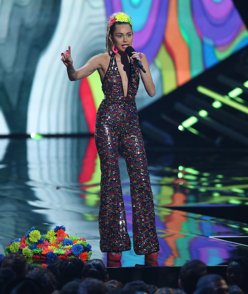 Host Miley Cyrus speaks at the MTV Video Music Awards at the Microsoft Theater on Sunday,...