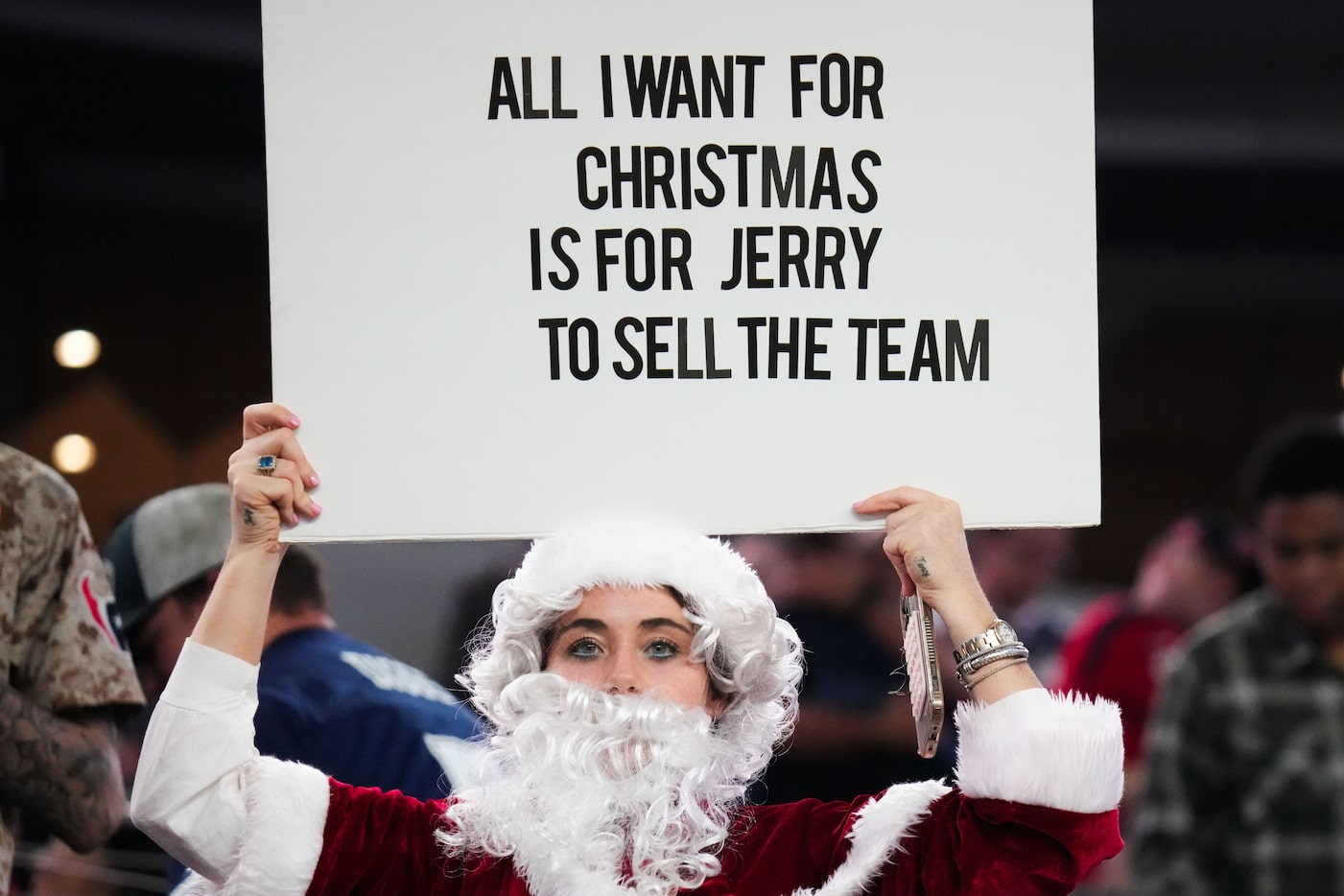 A fan holds a sign calling for Dallas Cowboys owner Jerry Jones to sell the team during the...