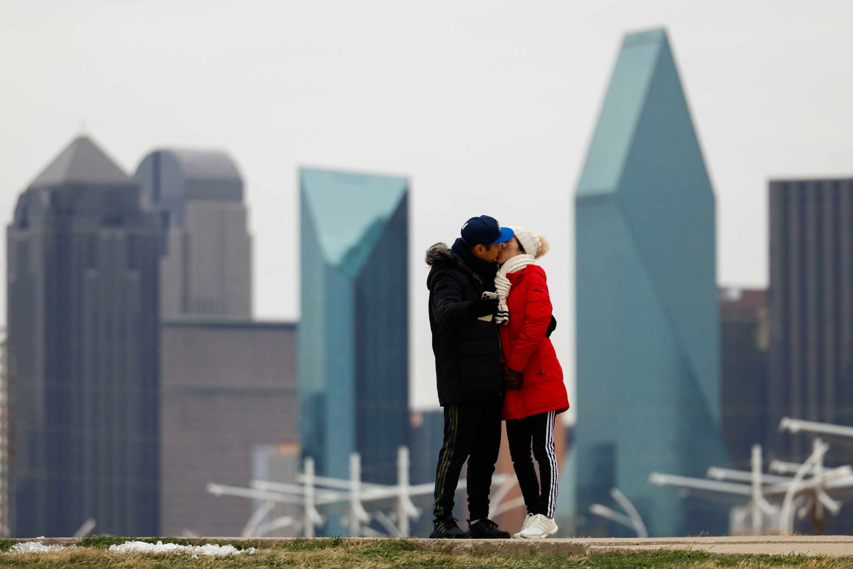 Daniel Woo (left), shares a kiss with Sanghee Woo while taking a walk at Ronald Kirk Bridge...