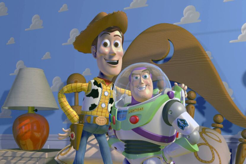 In this film publicity image released by Disney Pixar, characters Woody, left, and Buzz...