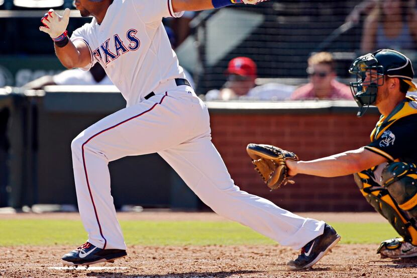 Texas Rangers shortstop Elvis Andrus singles and drives in two runs during the fifth inning...