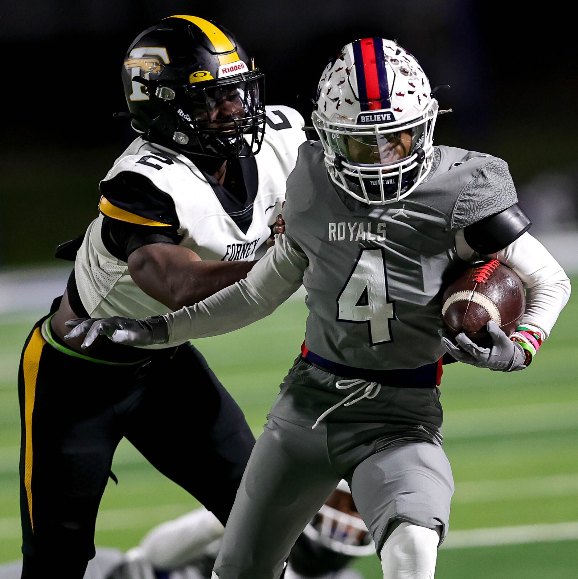 Richland wide receiver Deon Jones (4) gets pushed out of bounds by Forney linebacker Kelvion...