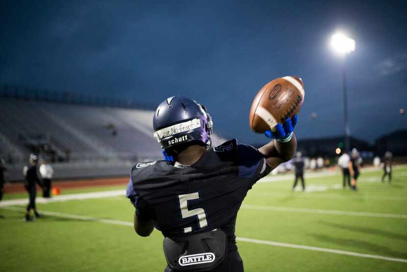 Wylie East quarterback Eno Benjamin warms  up before a varsity football game between...