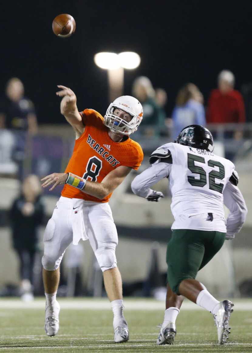 Aledo quarterback Dillon Davis (8) releases a pass before being hit by Mansfield Lake Ridge...