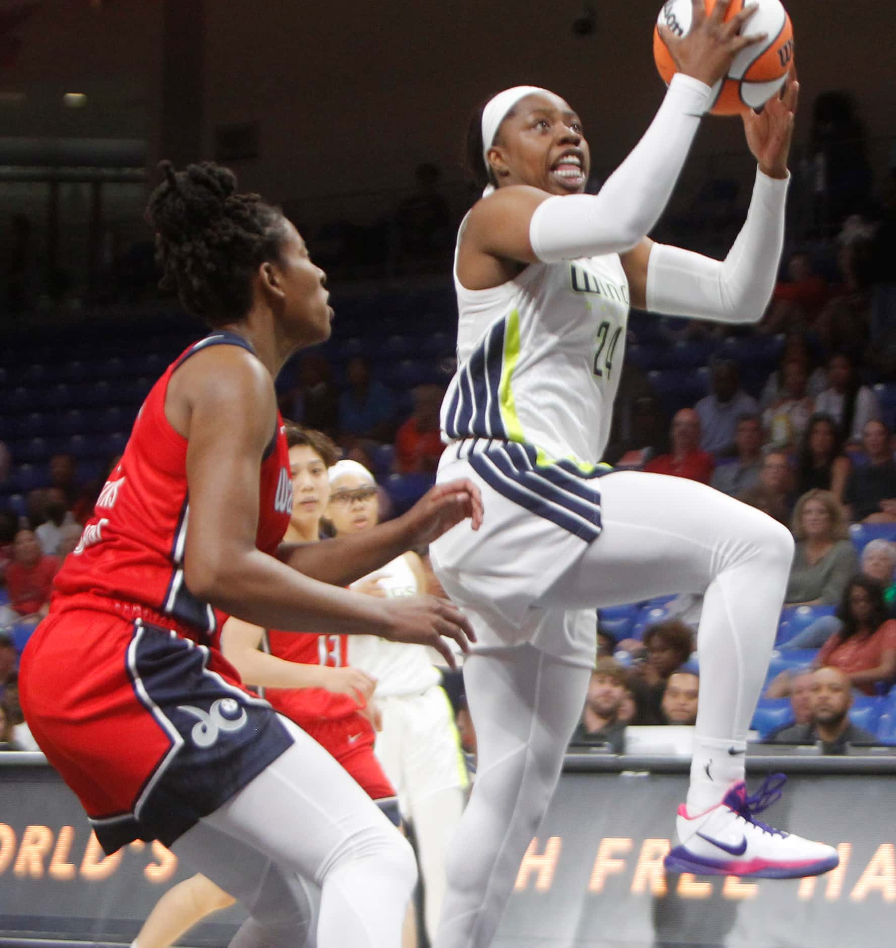 Dallas Wings guard Arike Ogunbowale (24) drives the lane to shoot as she is defended by...