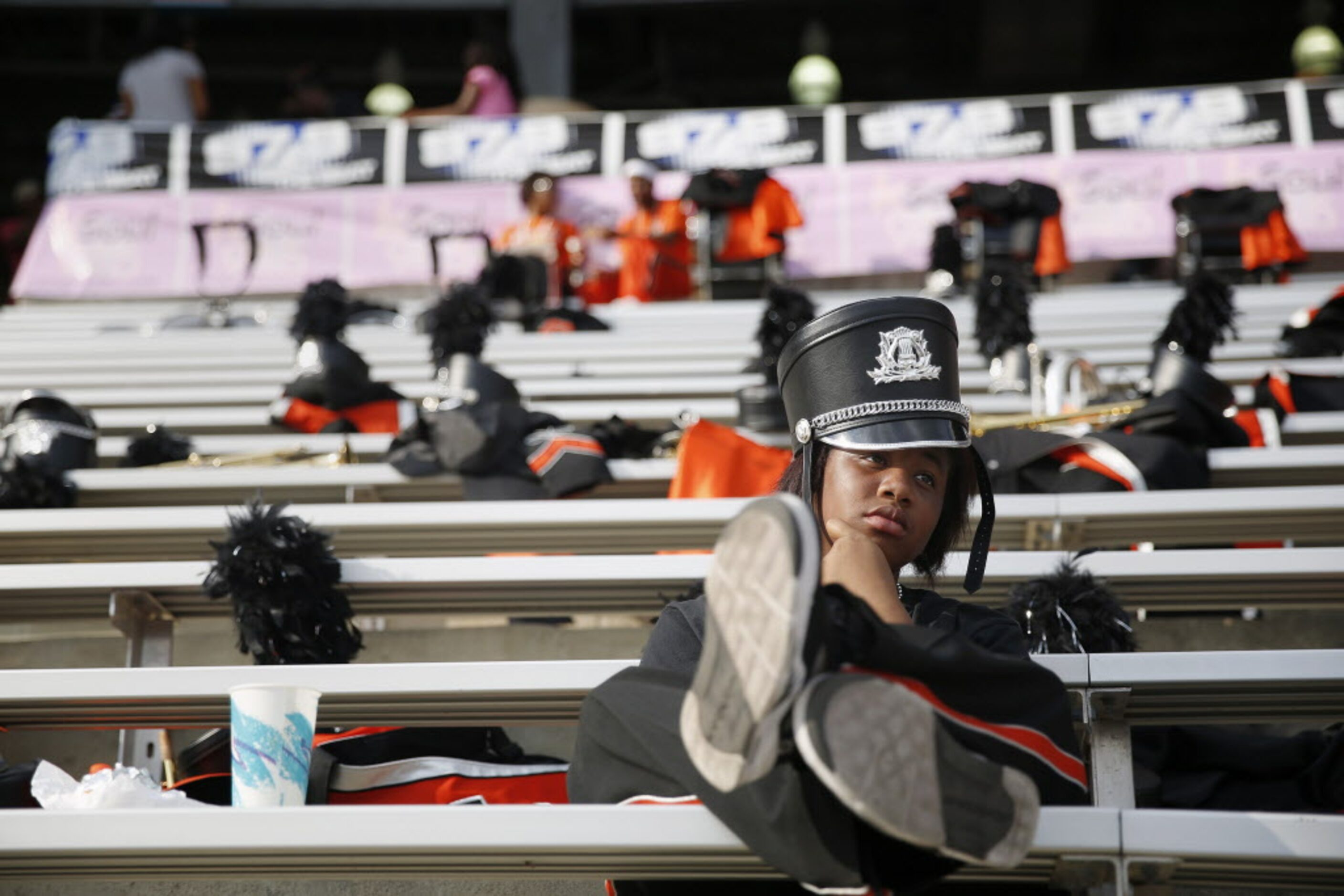 Clarinet player Jade Jeffrey, 15, of Lancaster, Texas, sits alone watching the game after...