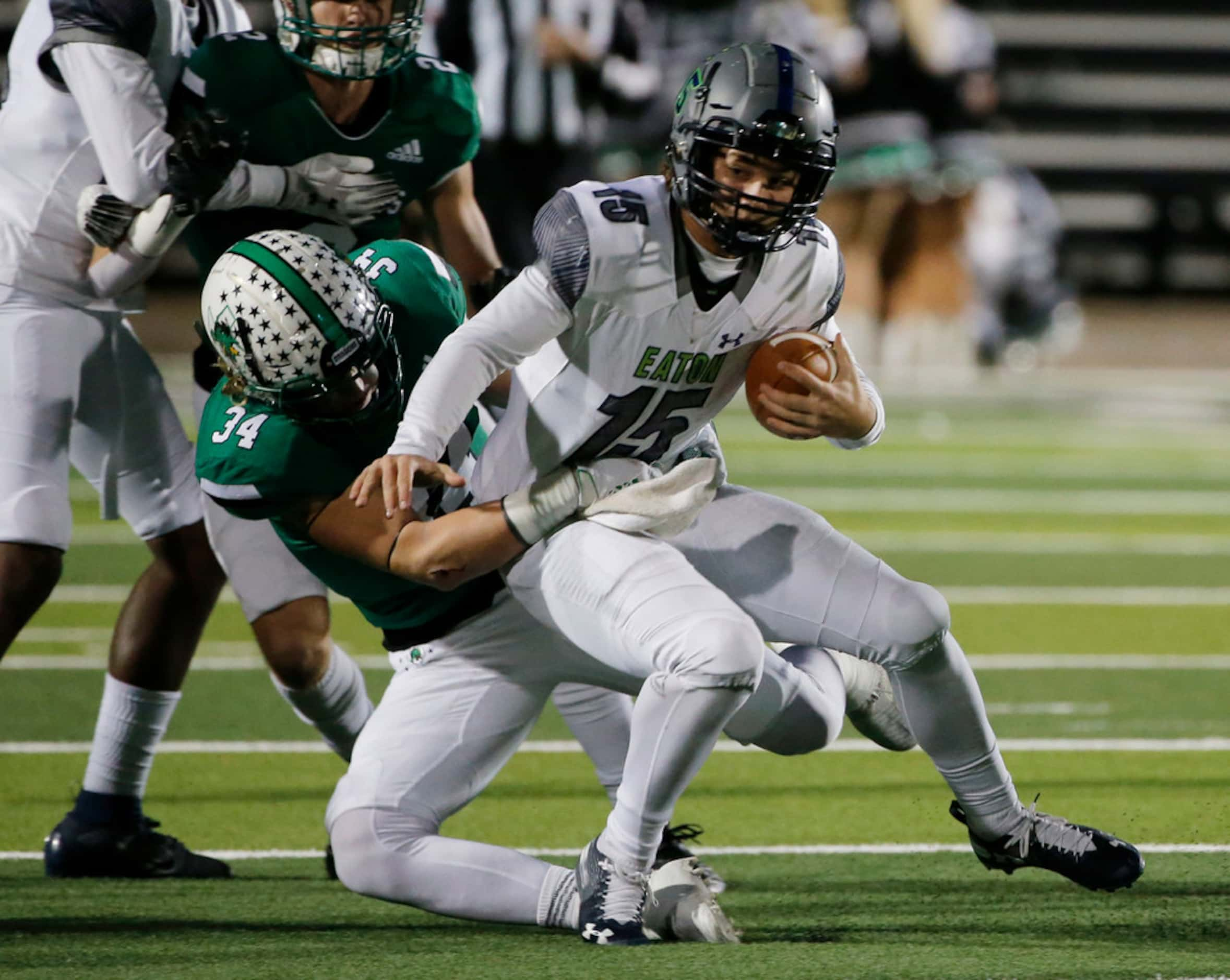 Southlake Carroll's Graham Faloona (34) tackles Eaton's Brandon St. Ama (15) during the...