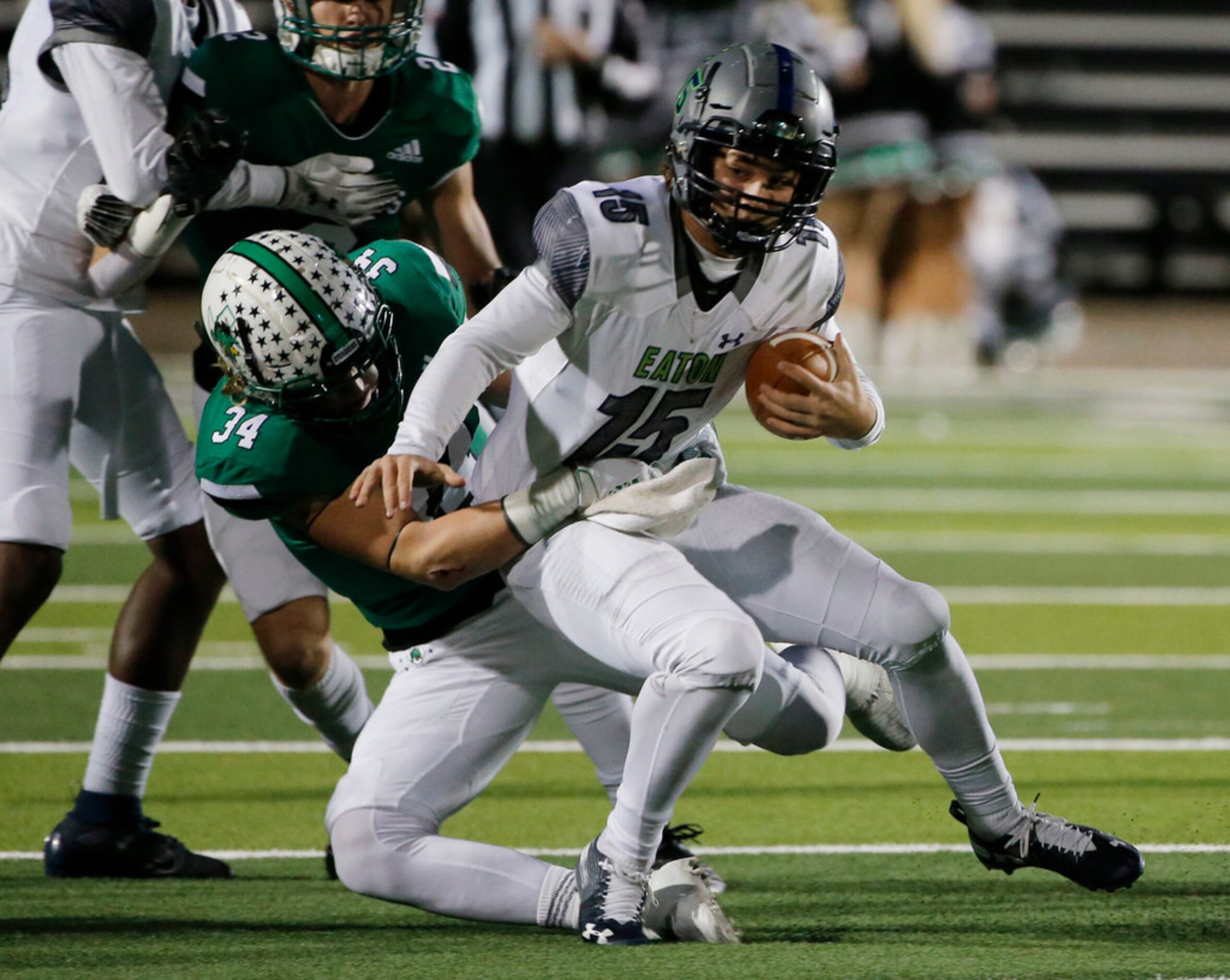 Southlake Carroll's Graham Faloona (34) tackles Eaton's Brandon St. Ama (15) during the...