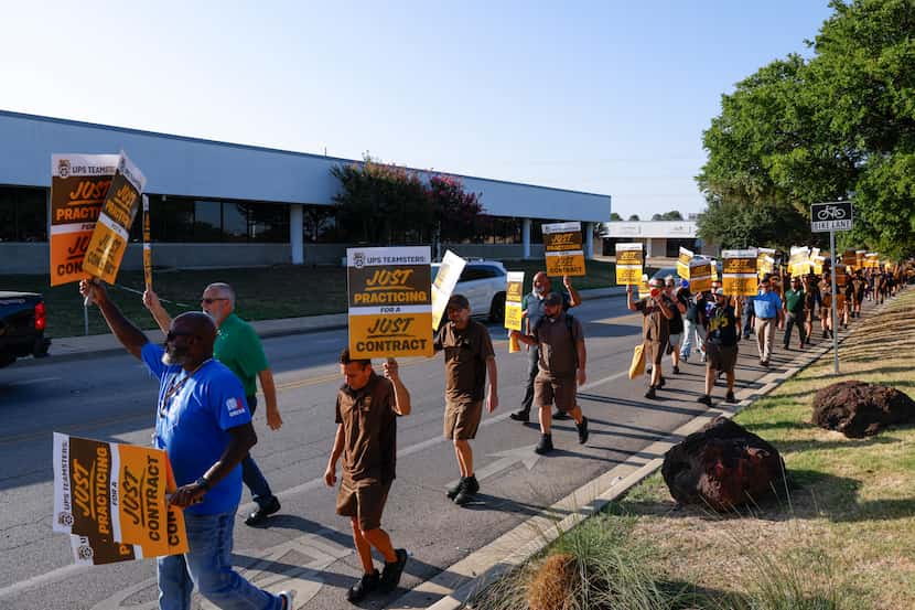UPS employees practice pickets along Monroe Dr. on Wednesday, July 12, 2023, in Dallas. UPS...