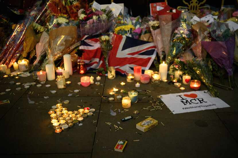 MANCHESTER, ENGLAND - MAY 23:  Candles and floral tributes are seen, following an evening...