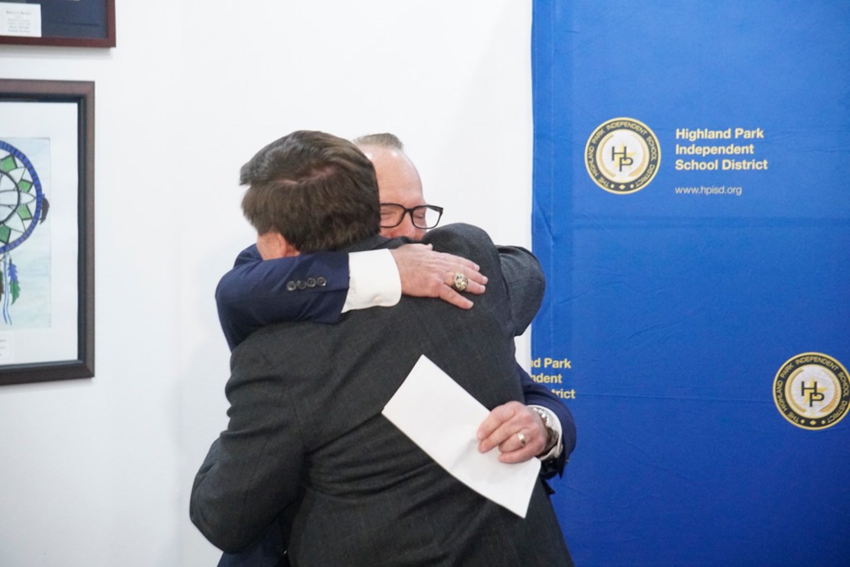 Highland Park High School head football coach Randy Allen hugs Athletic Director Johnny...