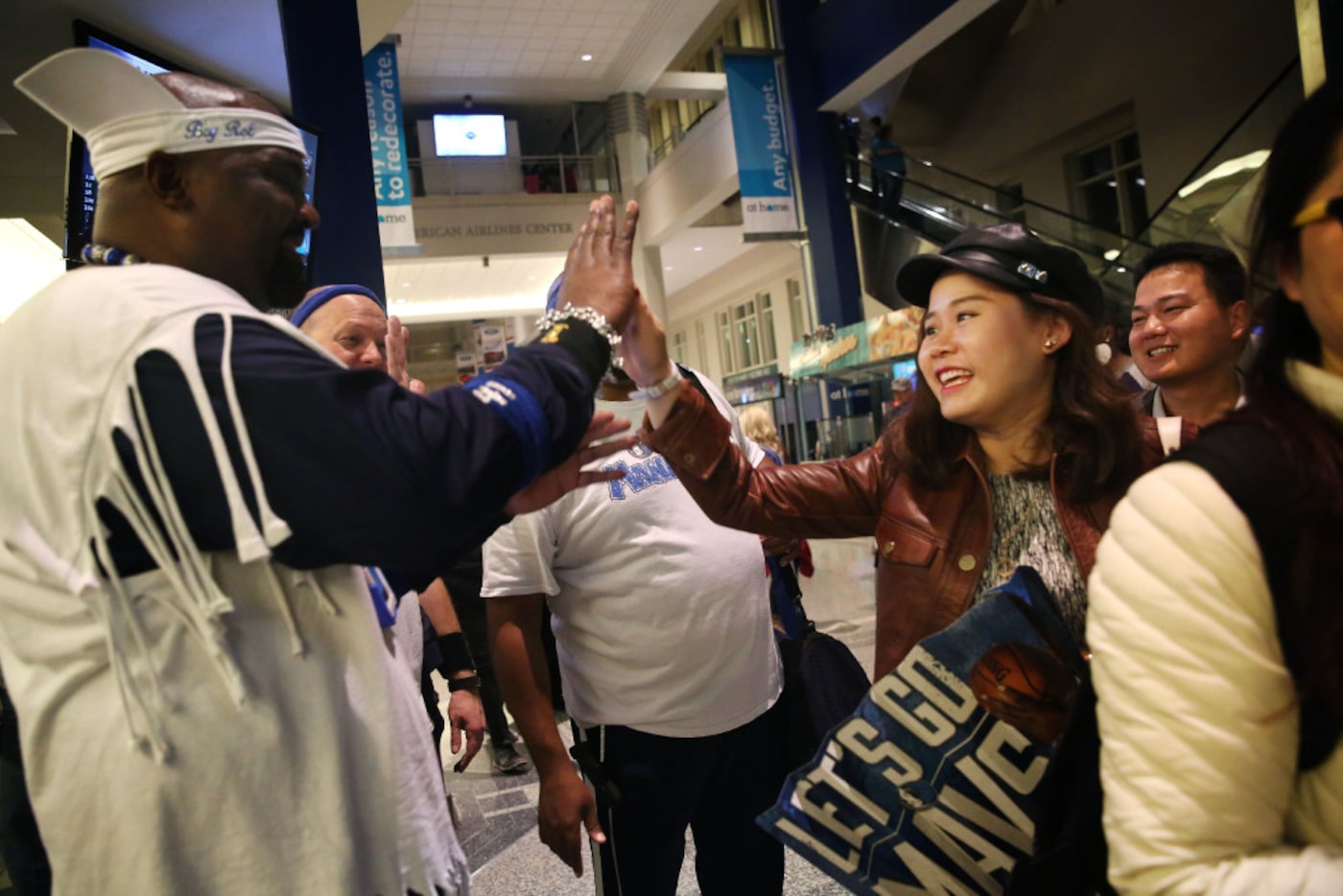 Mavs ManiAAC Rob Maiden, "Big Rob", high fives Leona Deng after a Mavericks game against the...