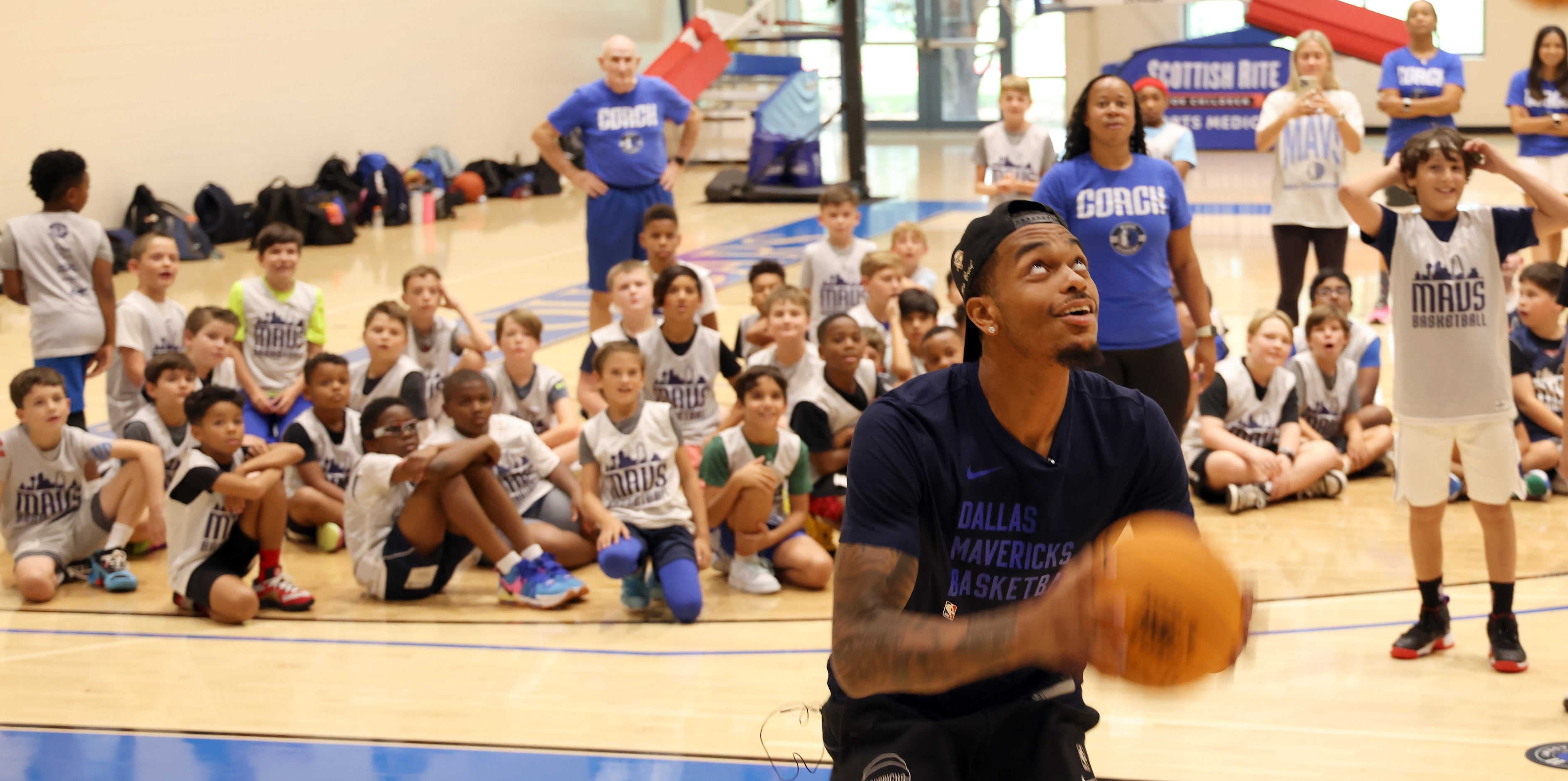 Dallas Mavericks forward and center PJ Washington drives to the basket under the watchful...