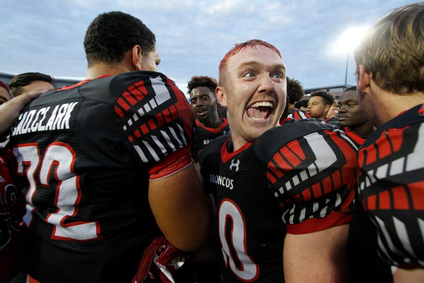 Mansfield Legacy running back Justin O'Shields (20) is ecstatic at midfield as he celebrates...