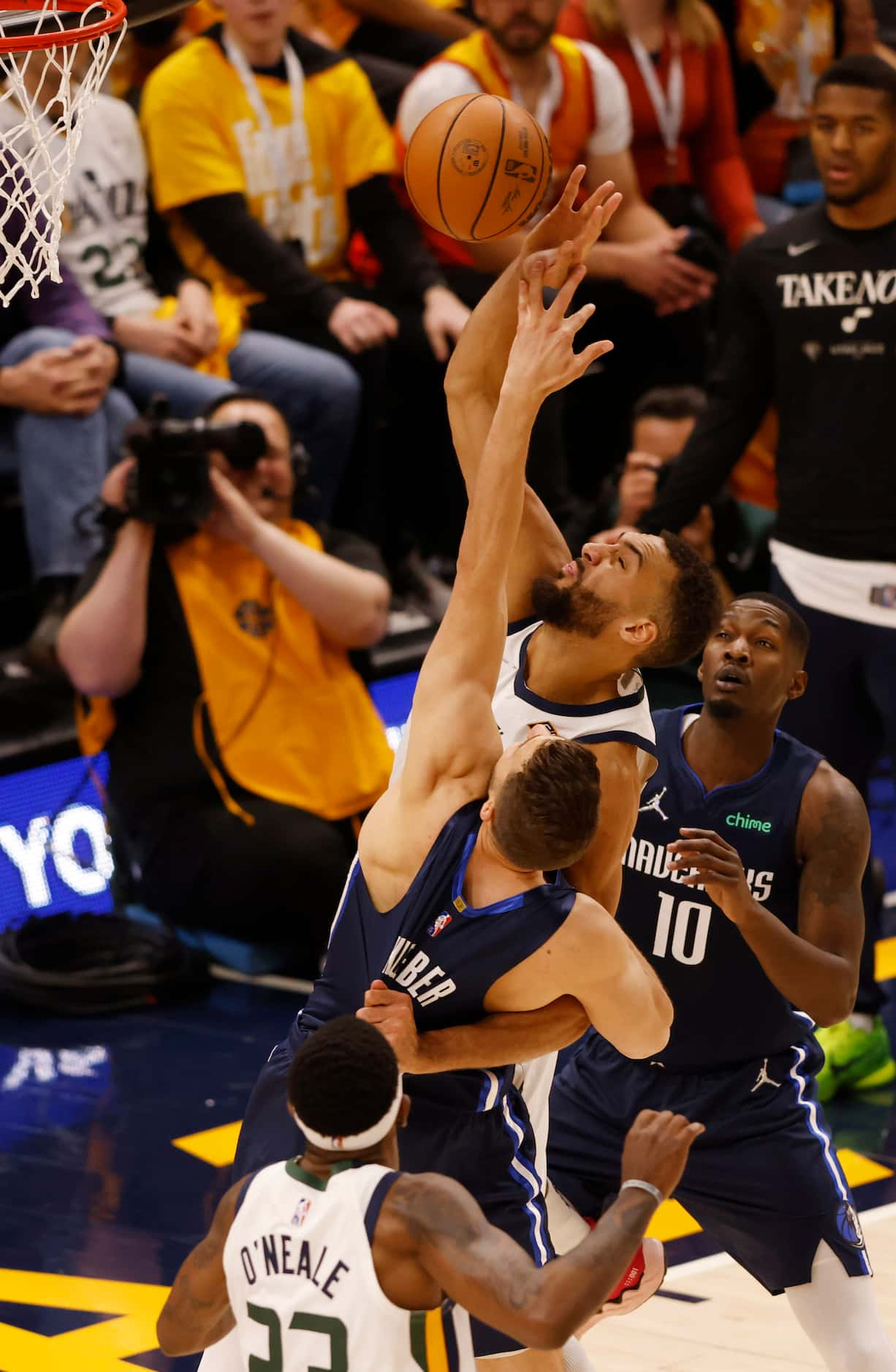 Utah Jazz center Rudy Gobert (27) pulls on the jersey of Dallas Mavericks forward Maxi...