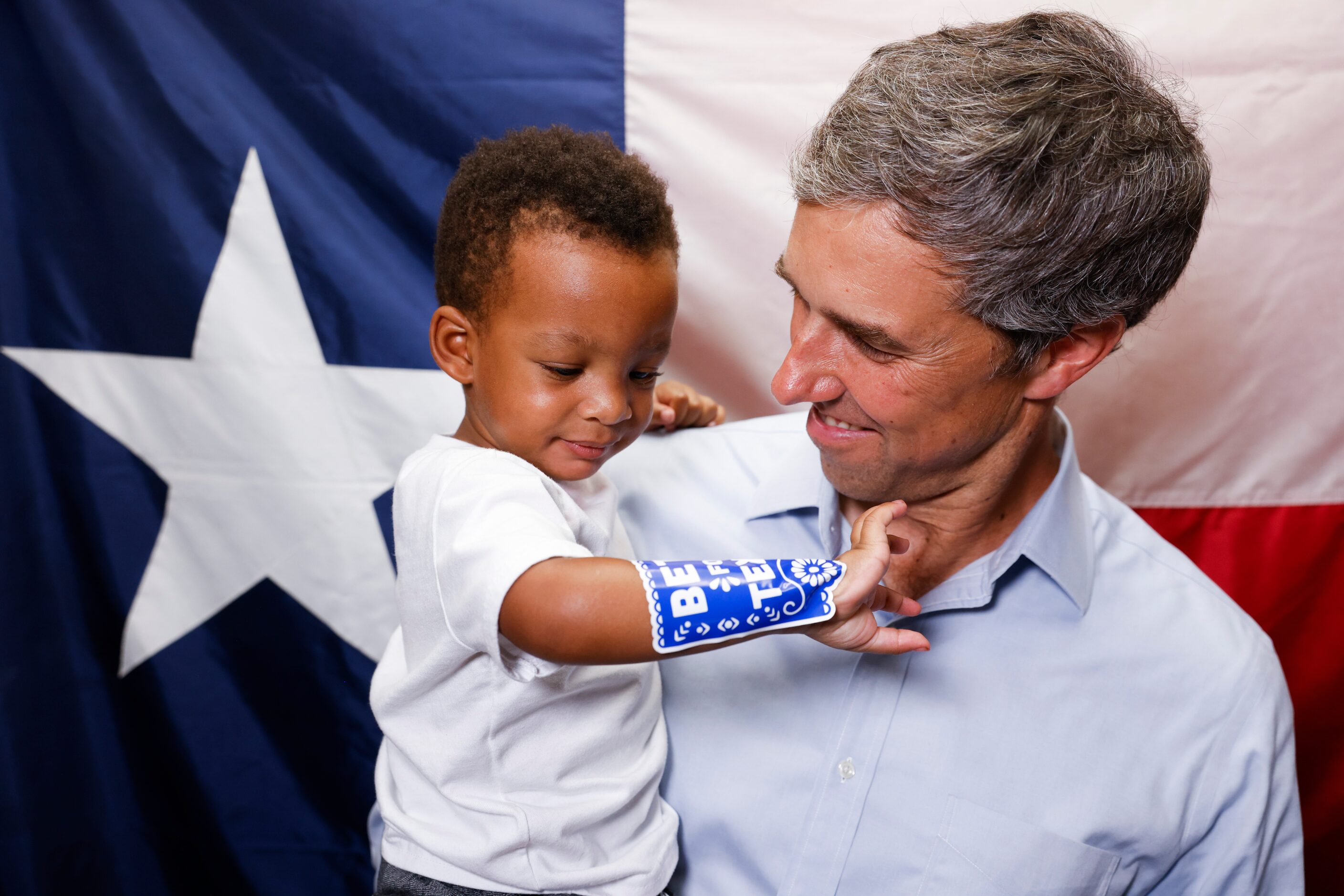 Texas Governor candidate Beto O'Rourke, right, looks towards Hayden Hammonds, 1, as takes a...