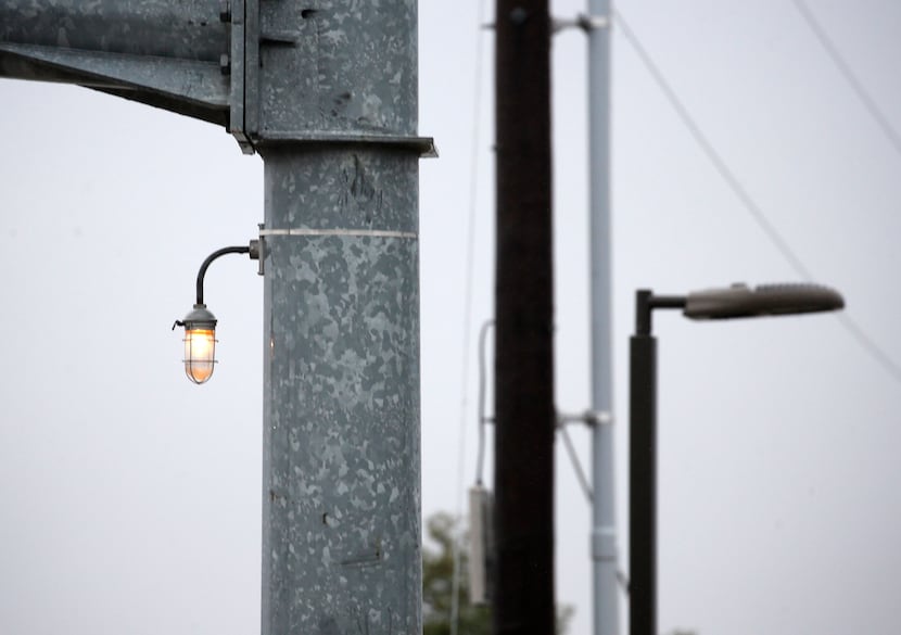 This white light affixed to a traffic stoplight arm at Campbell and Coit roads is one of...