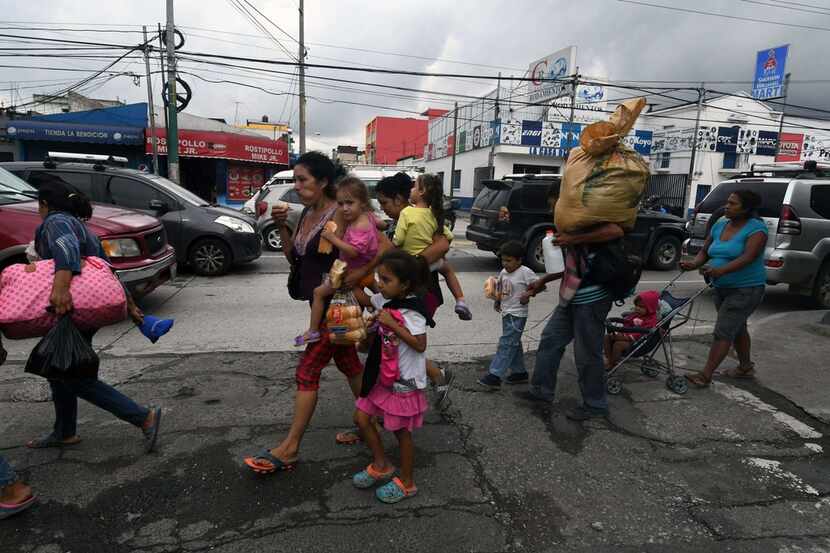 Honduran migrant families taking part in a caravan to the United States arrived in Guatemala...