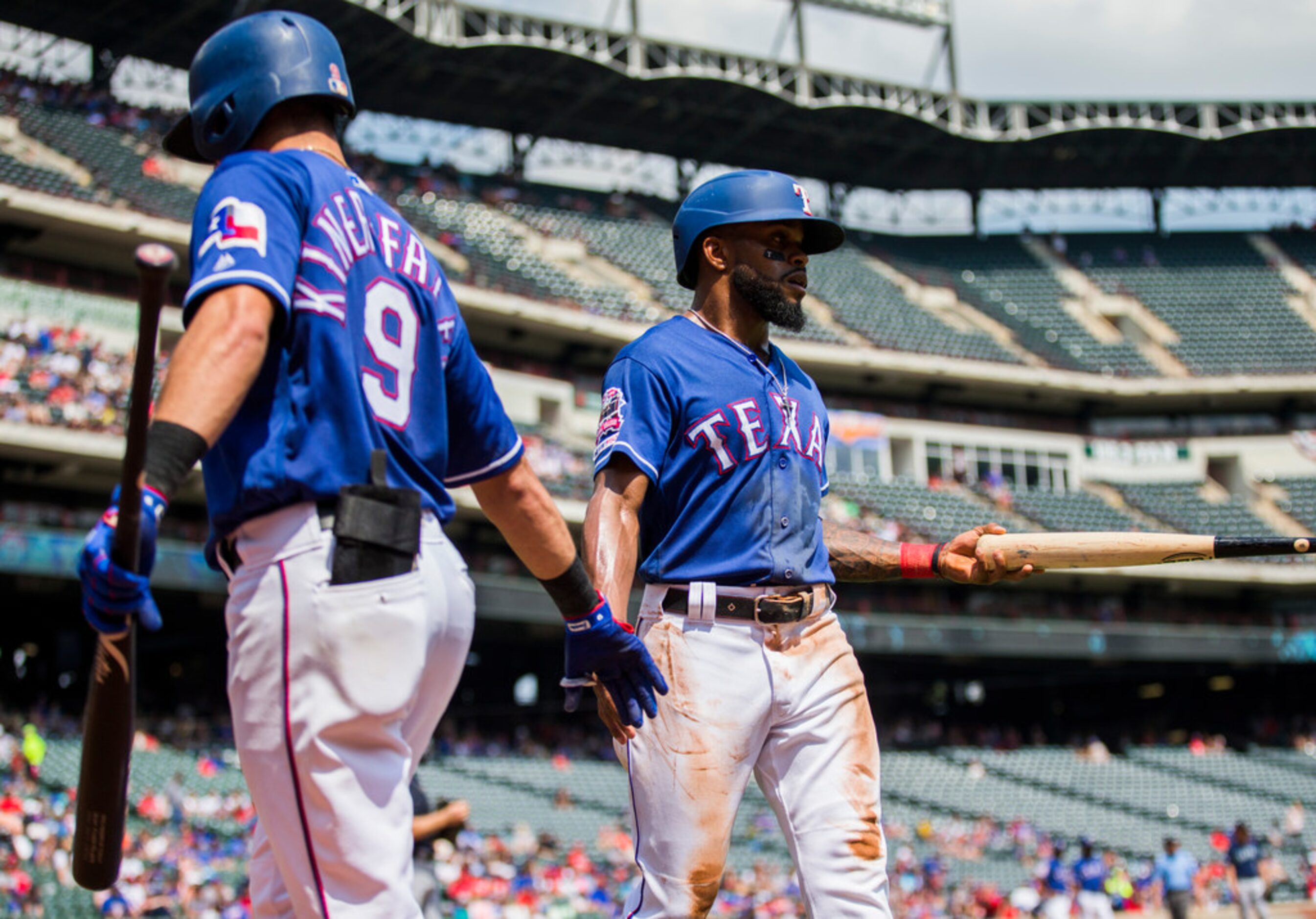 Texas Rangers center fielder Delino DeShields (3) gets a high-five from third baseman Isiah...