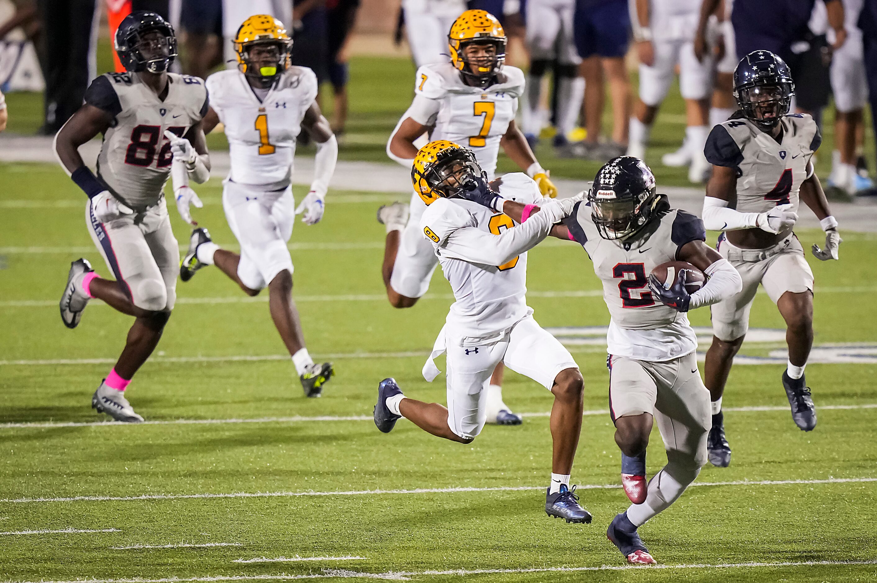 Allen running back Kayvion Sibley (2) pushes away from McKinney defensive back Ashton...