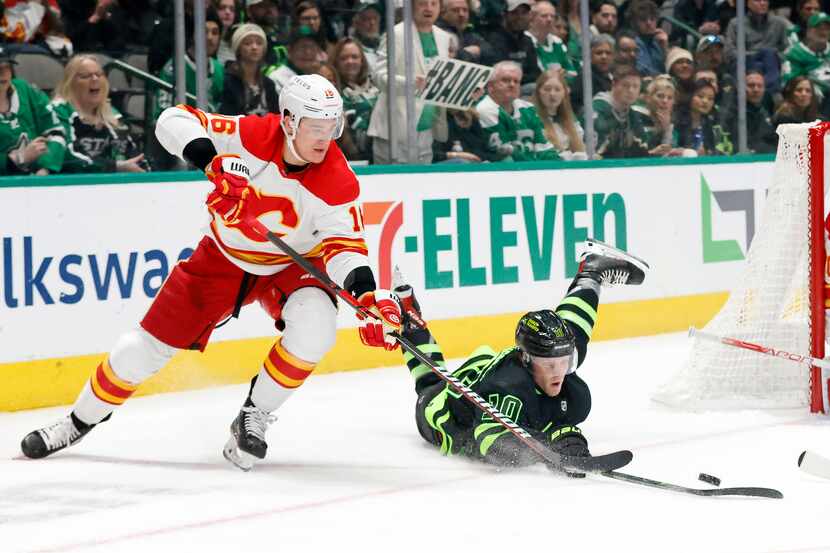 Dallas Stars center Ty Dellandrea (10) goes to the ice in attempt to pass against Calgary...