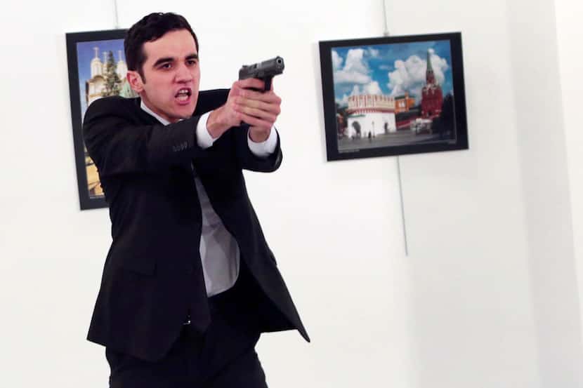 An unnamed gunman gestures after shooting the Russian Ambassador to Turkey, Andrei Karlov,...
