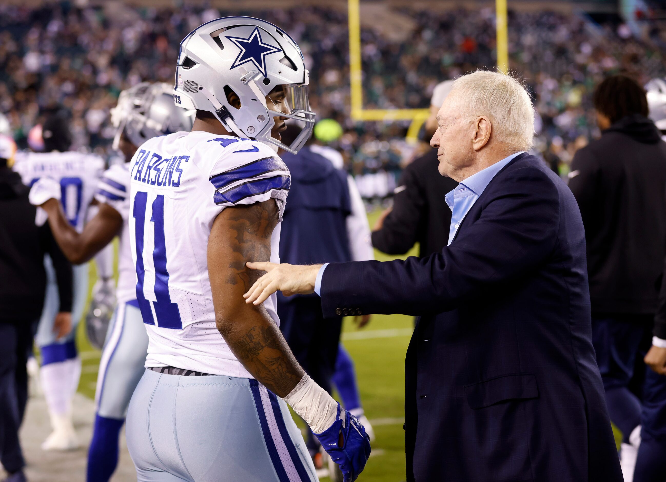 Dallas Cowboys owner Jerry Jones visits with linebacker Micah Parsons (11) during pregame...