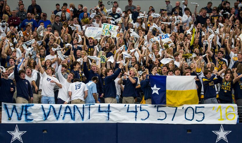 Highland Park fans cheer as their team takes the field before the UIL Class 5A Division I...