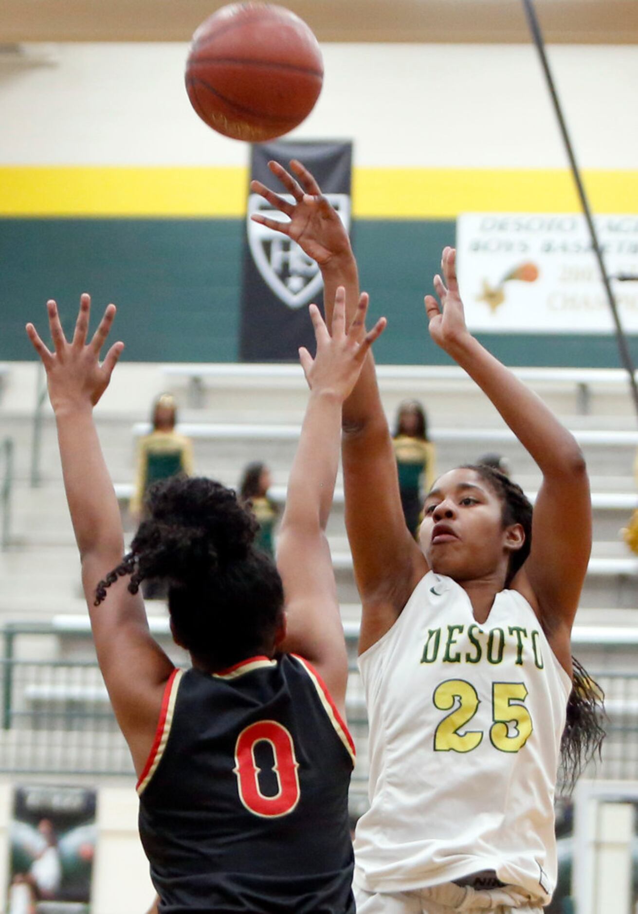 DeSoto's Ash'a Thompson (25) scores two of her first half points over the defense of South...