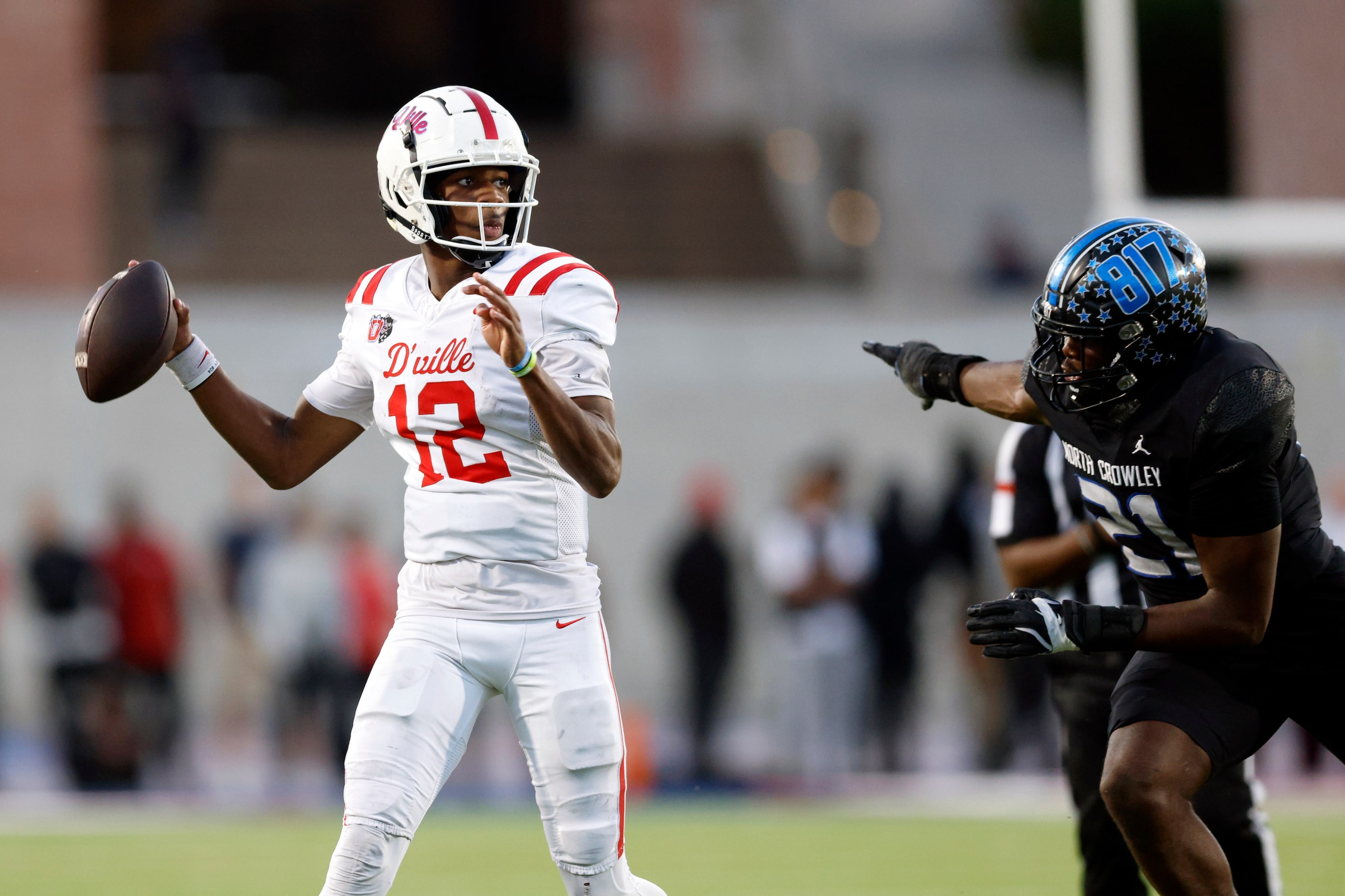 Duncanville quarterback Keelon Russell (12) looks to throw as he scrambles away from North...