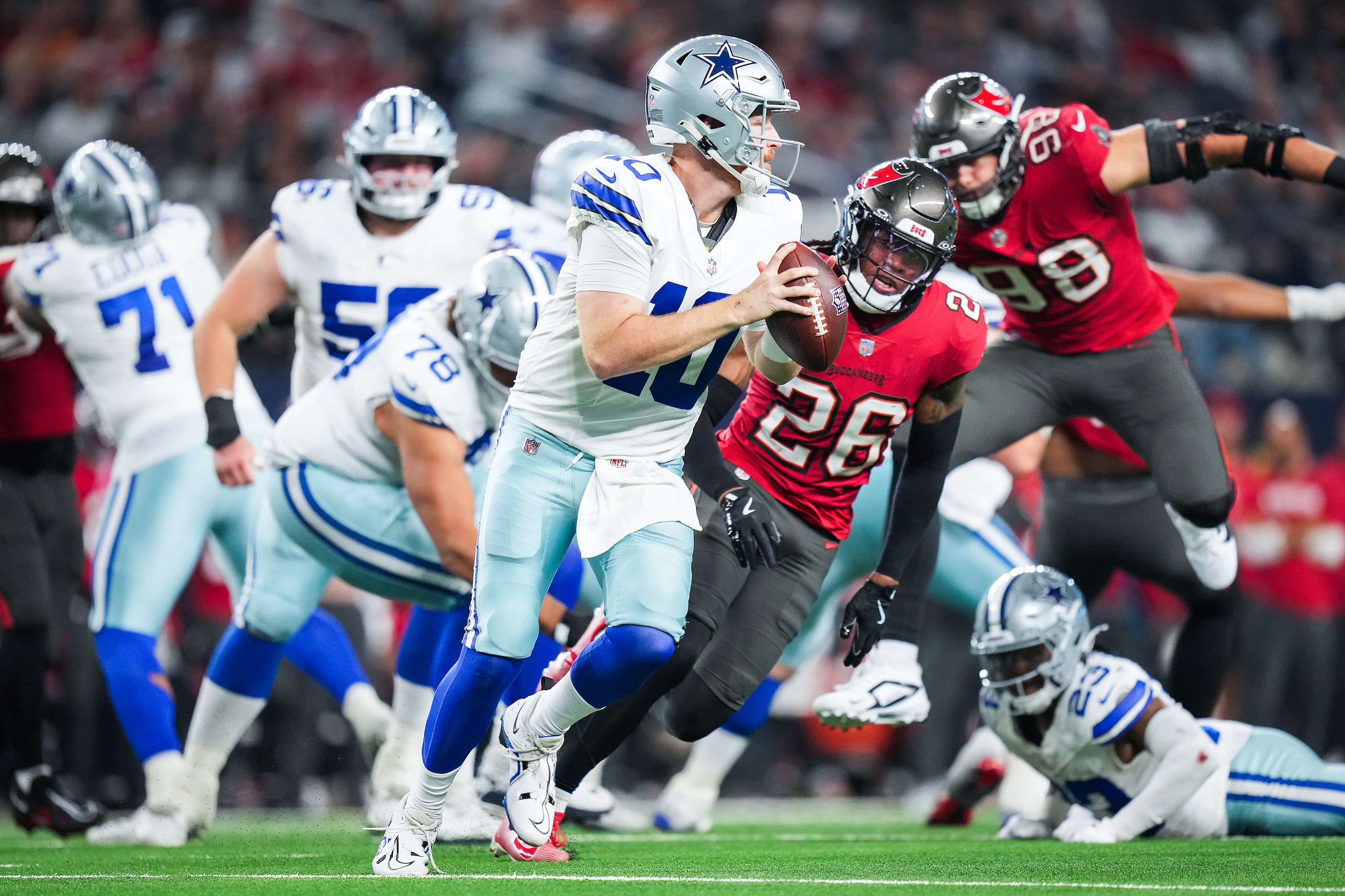 Dallas Cowboys quarterback Cooper Rush (10) scrambles away from Tampa Bay Buccaneers safety...