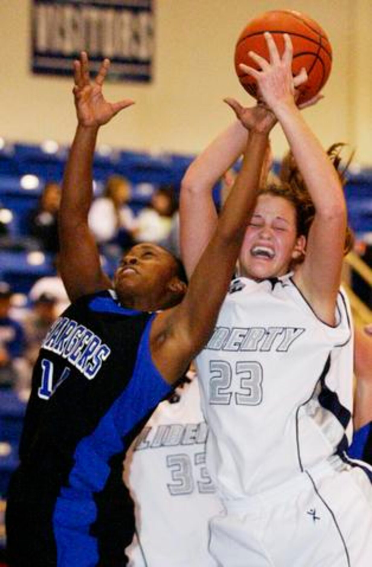 Argyle Liberty Christian senior forward Whitney Hand (23) wins the rebound over Dallas...