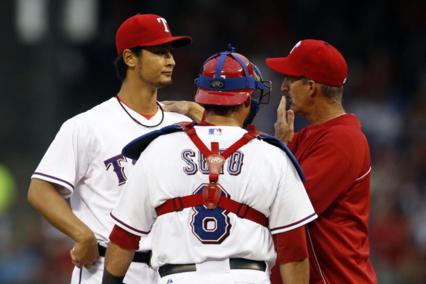 Texas Rangers starting pitcher Yu Darvish (11), left, talks with catcher Geovany Soto (8)...