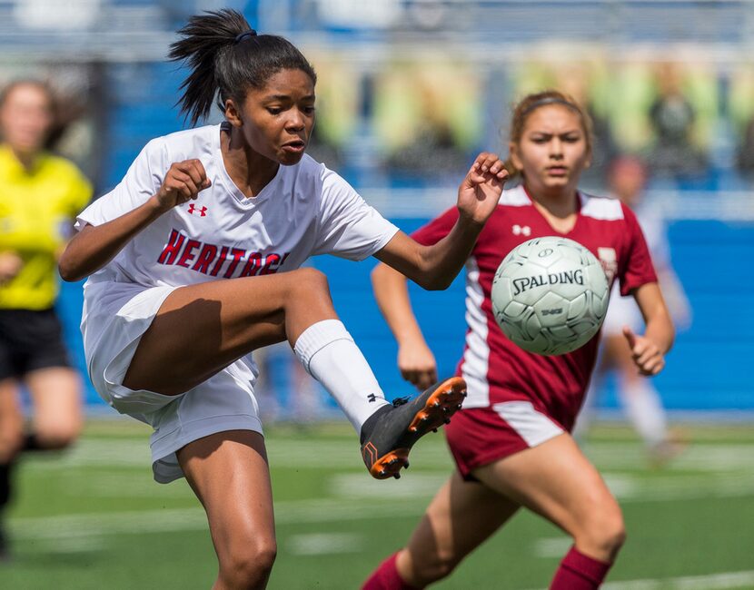 Midlothian Heritage's Rachel Allen takes the ball to the ground past Jasper's Marissa Lopez...