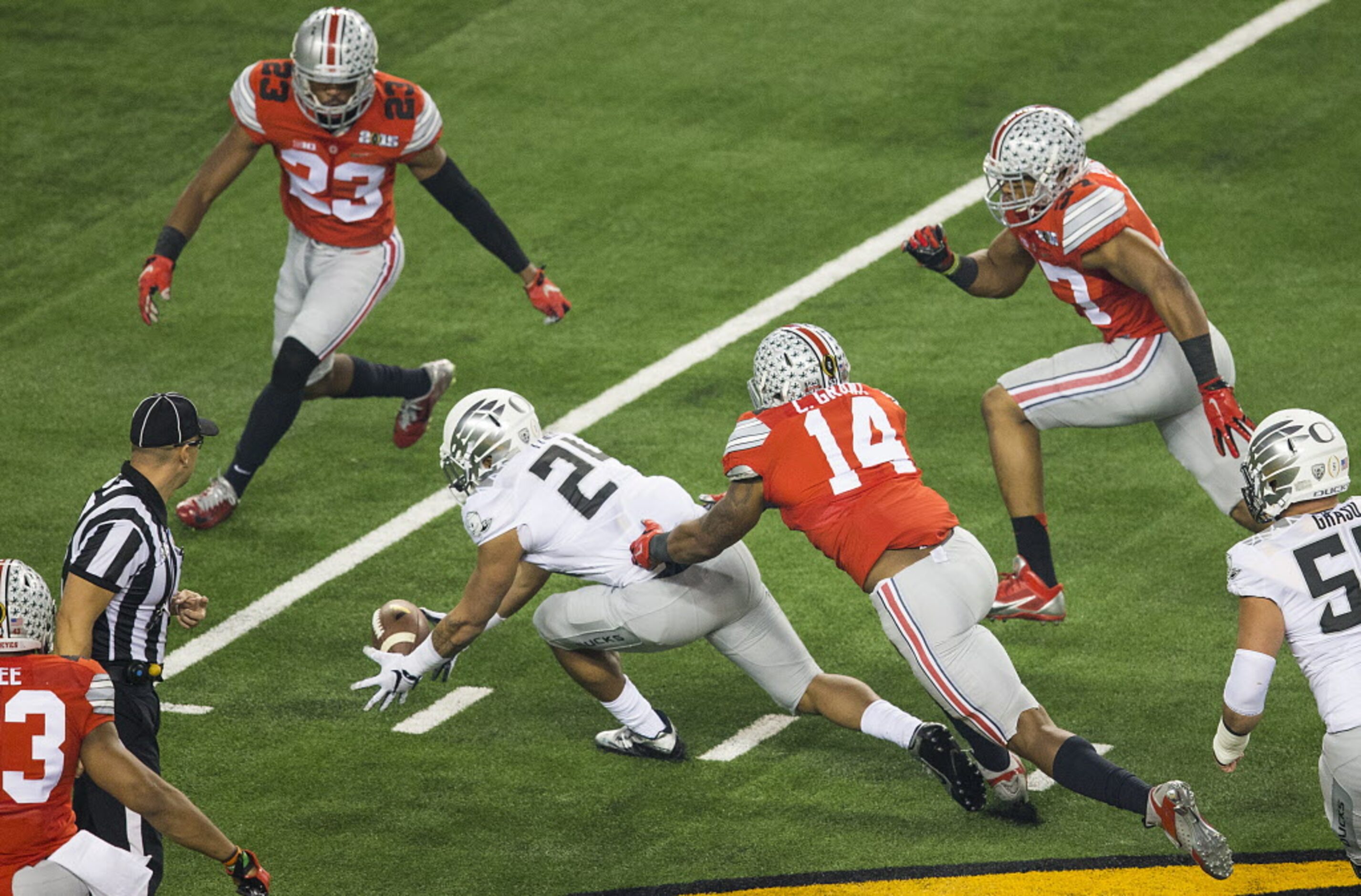 Oregon Ducks running back Thomas Tyner (24) recovers his own fumble as Ohio State Buckeyes...