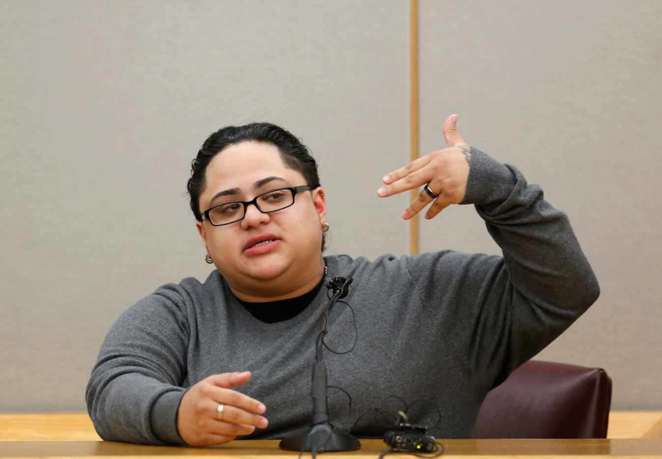 Monique Arredondo shows how Roy Oliver pointed a gun at her after a traffic accident two...