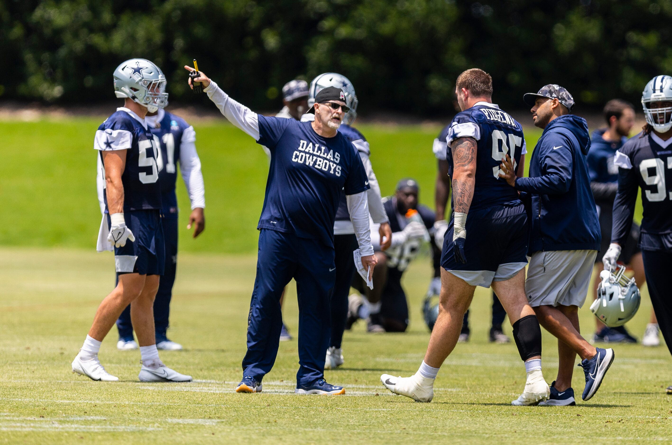 Dallas Cowboys Defensive Coordinator Dan Quinn directs defensive tackle John Ridgeway (95)...