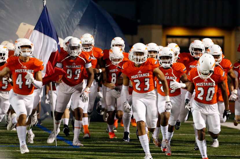The Sachse Mustangs take the field prior to the start of a high school playoff football game...