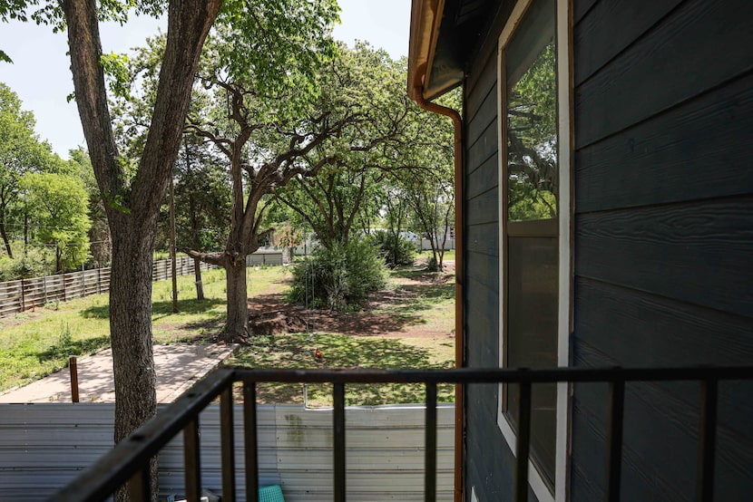 White siding is all that separates the Rojas family's home from a recycling and waste...