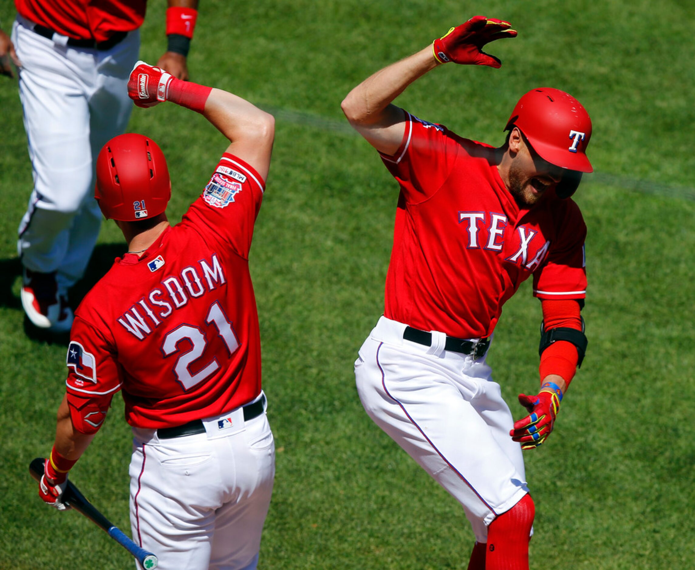 Texas Rangers right fielder Hunter Pence (right) is congratulated by teammate Patrick Wisdom...