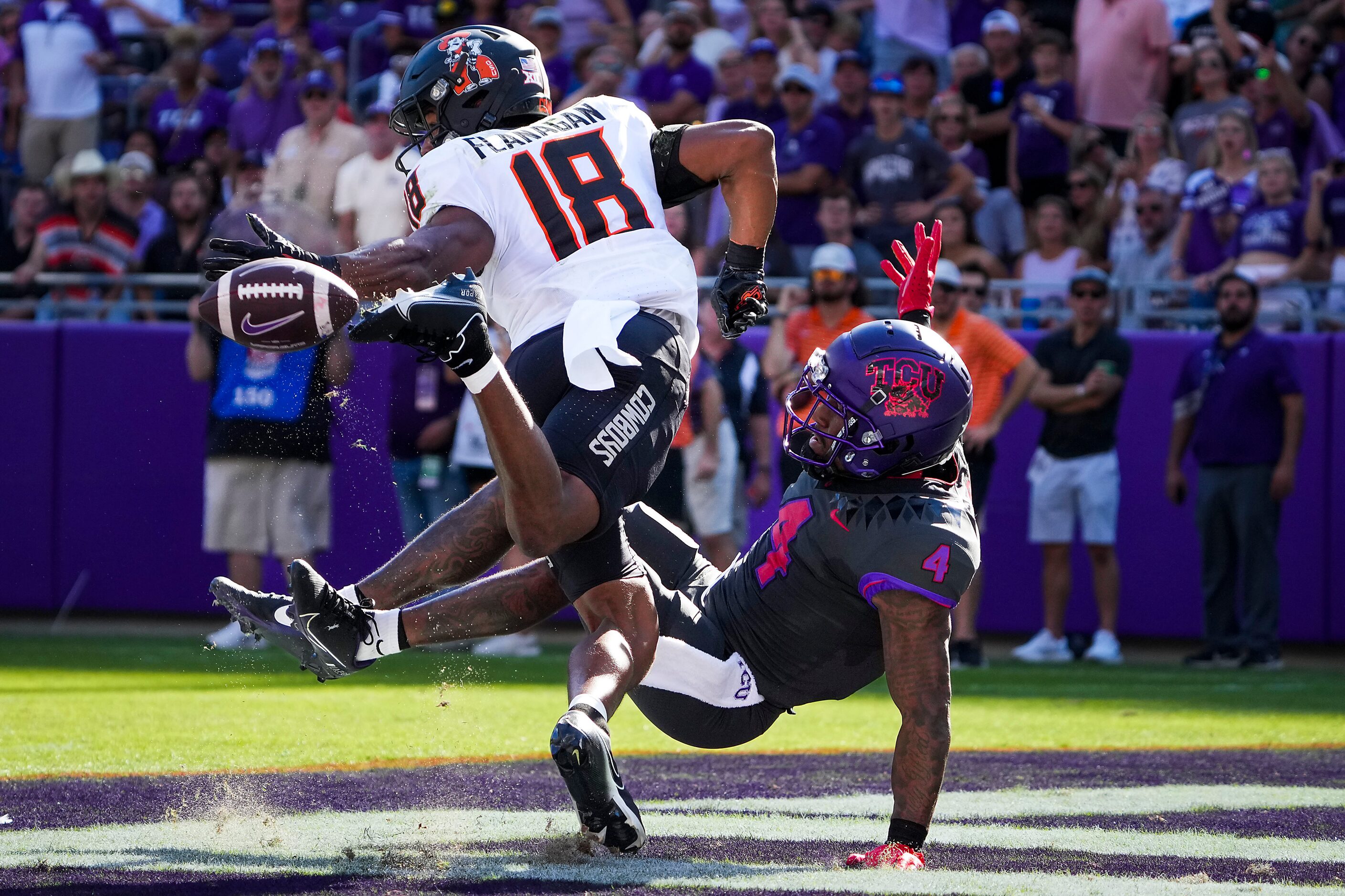 Oklahoma State safety Sean Michael Flanagan (18) breaks up a pass intended for TCU wide...