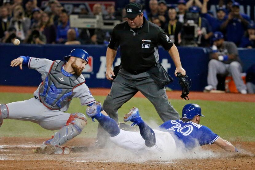 Toronto Blue Jays third baseman Josh Donaldson (20) slides home with the winning run in the...